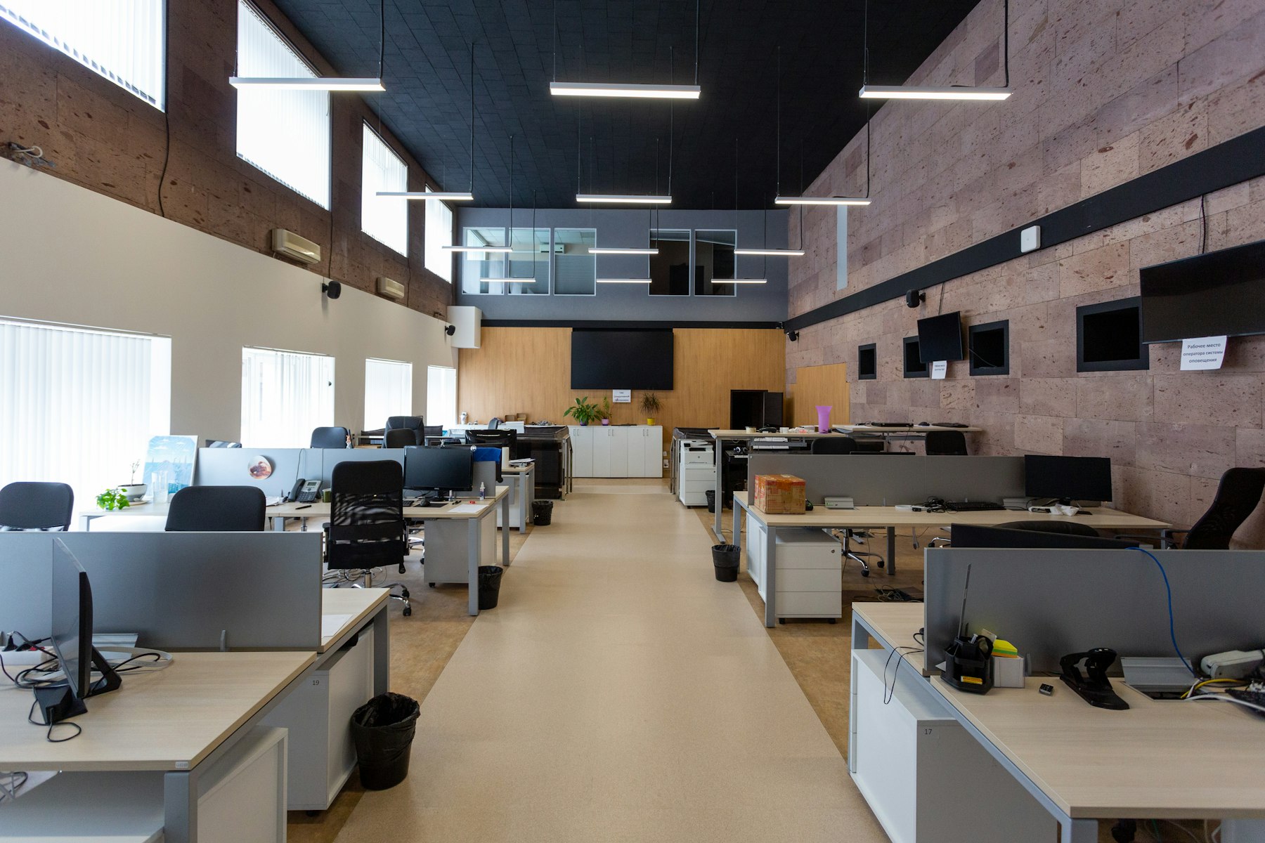 An empty open-plan office with rows of desks