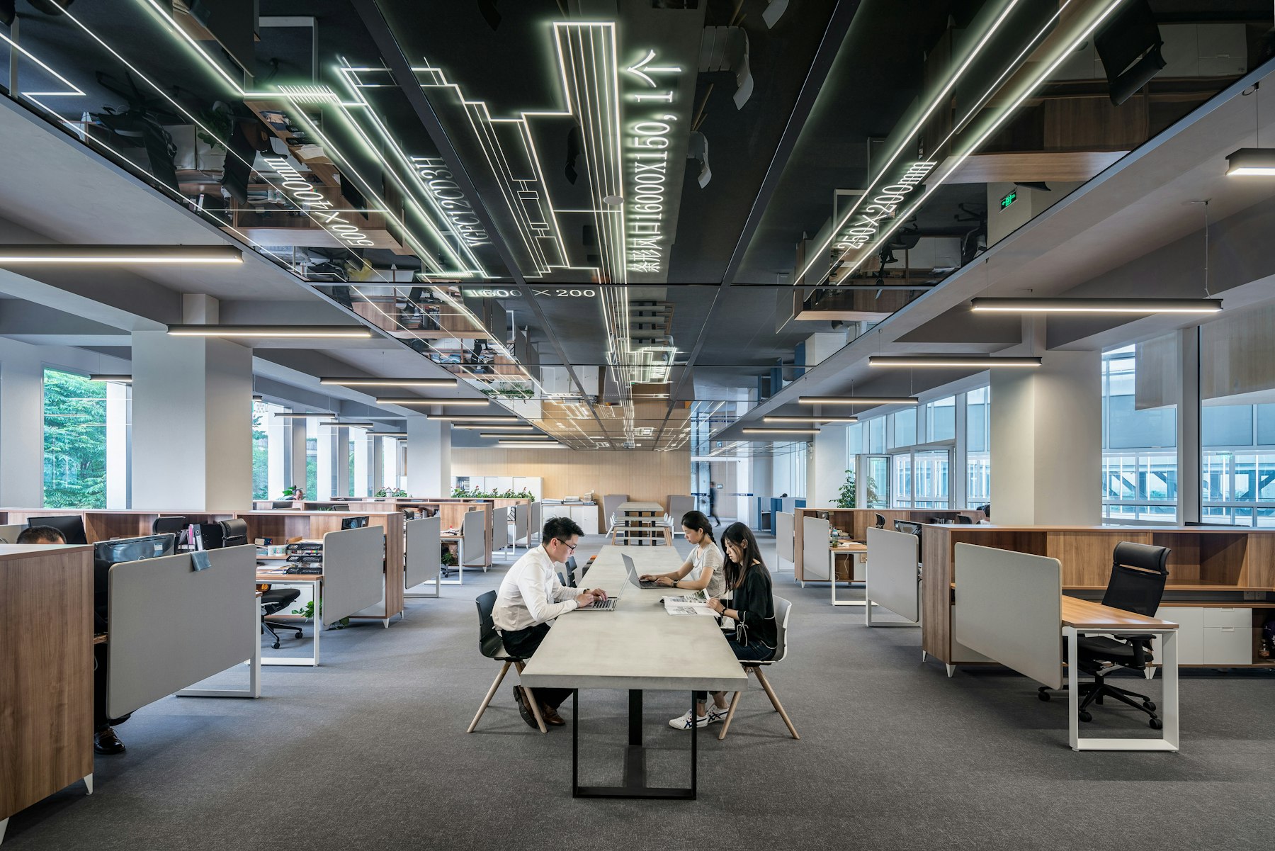 People working in a large open-plan office